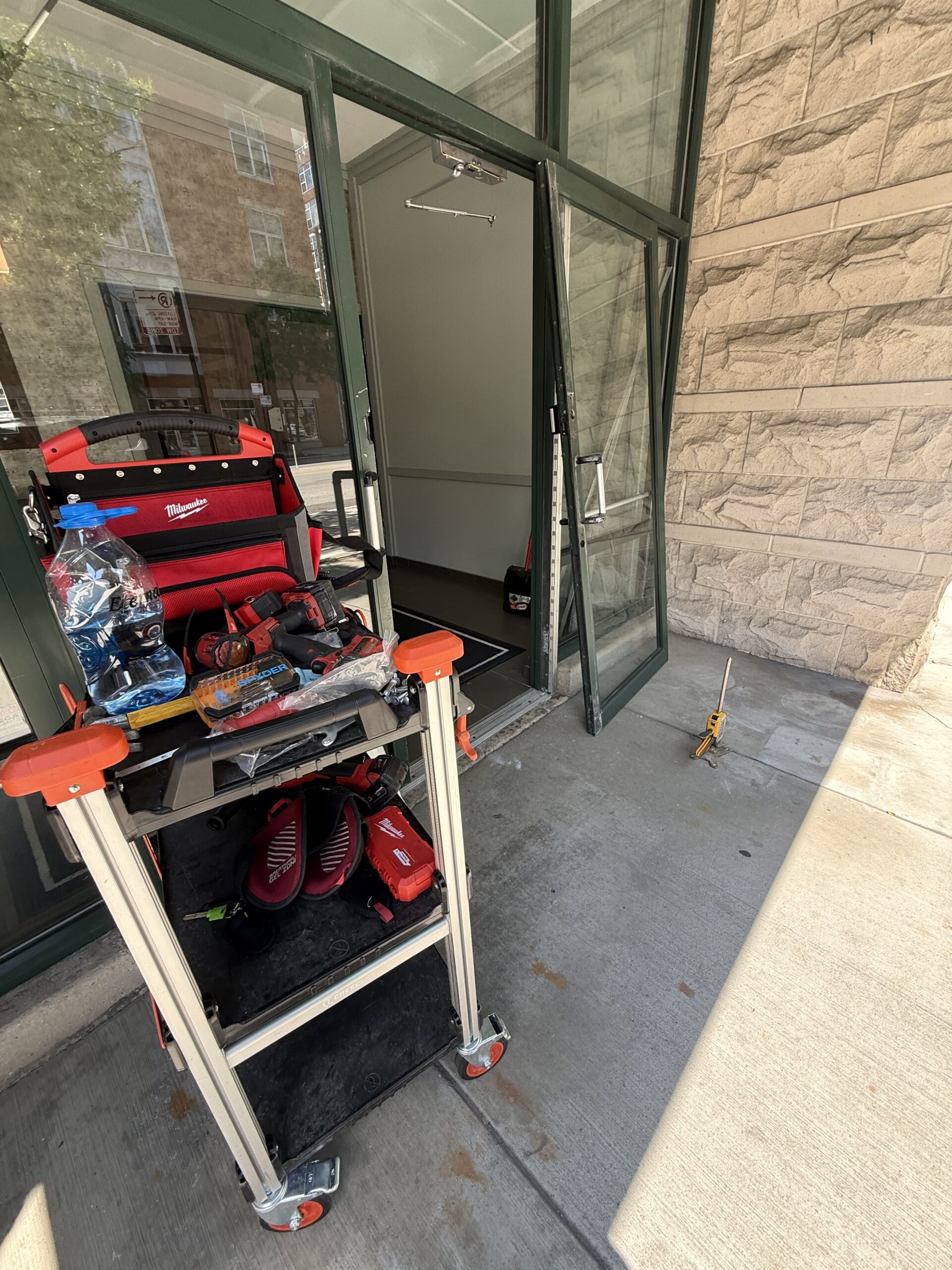 Locksmith repairing commercial storefront door in Chicago Illinois