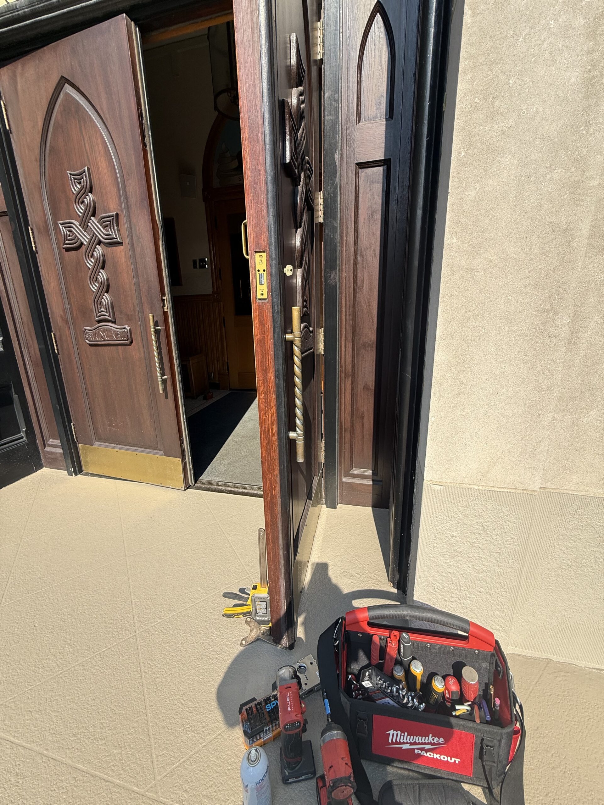 Commercial locksmith repairing storefront door hardware in Hyde Park Chicago
