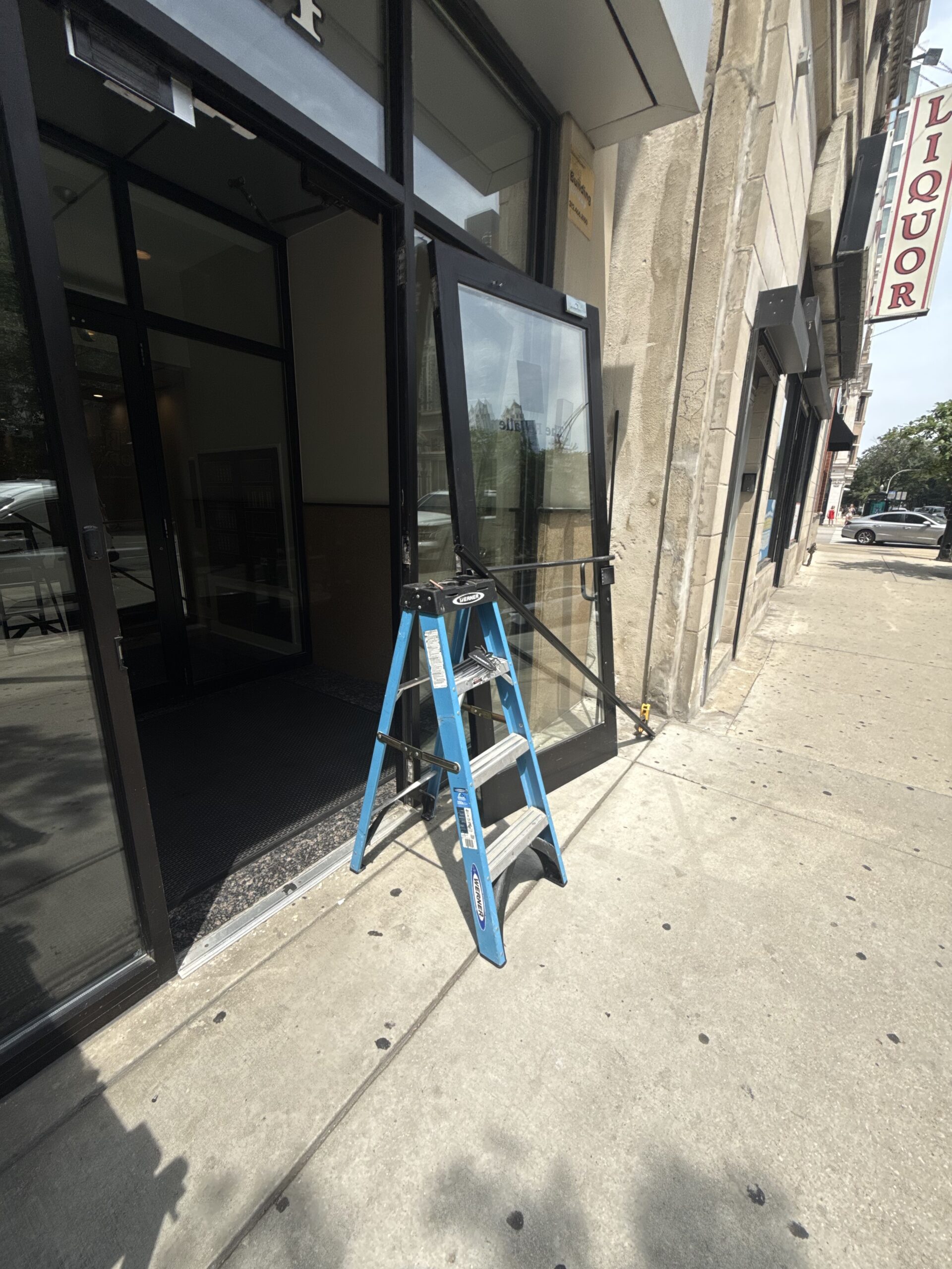 Aluminum storefront door repair with Roton hinge in Pilsen Chicago